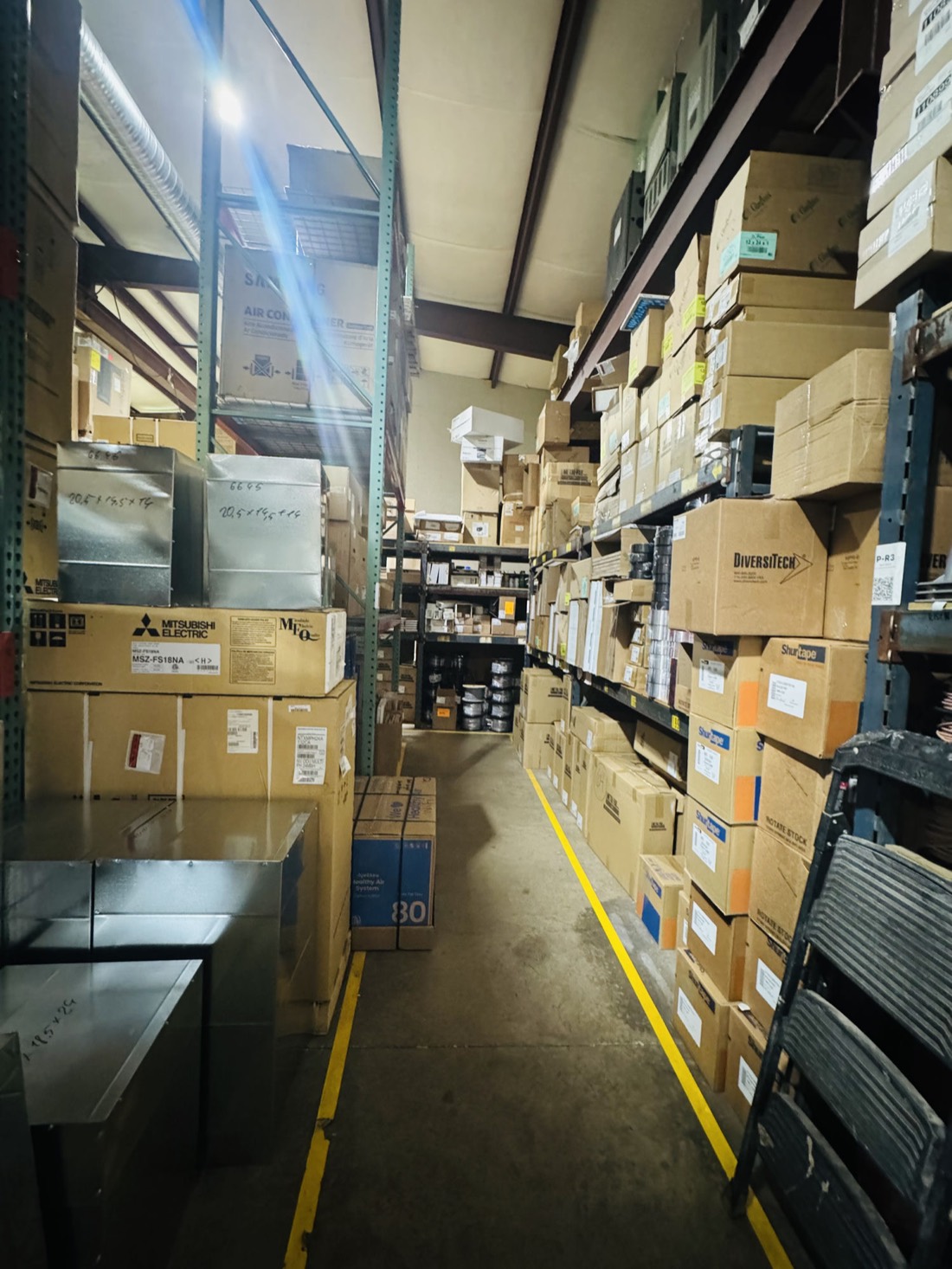 Inside the Cold Mountain Supply warehouse — aisles stocked with HVAC equipment and materials